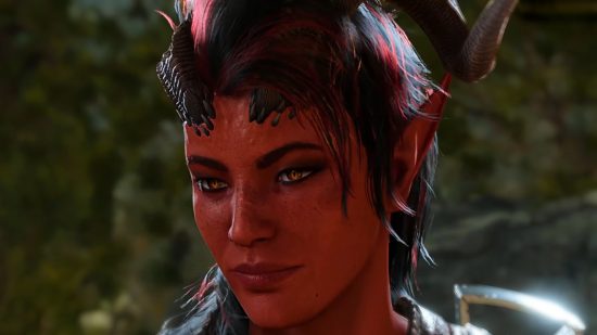 A devilish-looking woman with crimson colored skin and one black horn smiles to the side